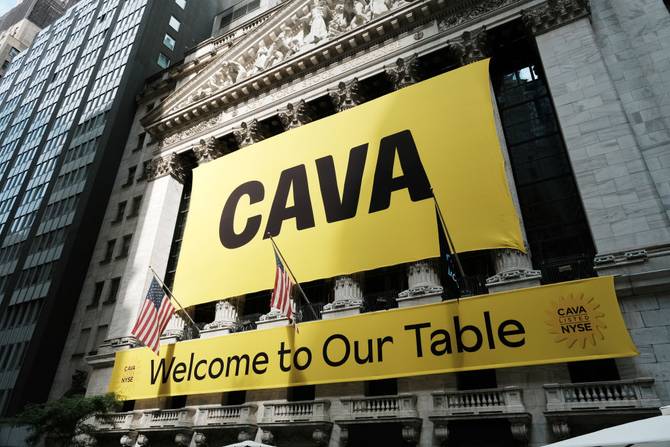 A banner for the Mediterranean restaurant chain Cava is displayed outside of the New York Stock Exchange (NYSE) as the company goes public on June 15, 2023