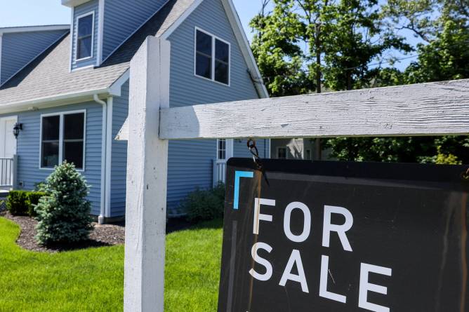 A "for sale" sign outside of a home