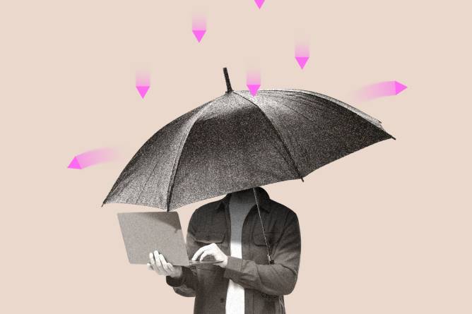 A person holding a laptop under an umbrella, shielding them from looming cyber threats.