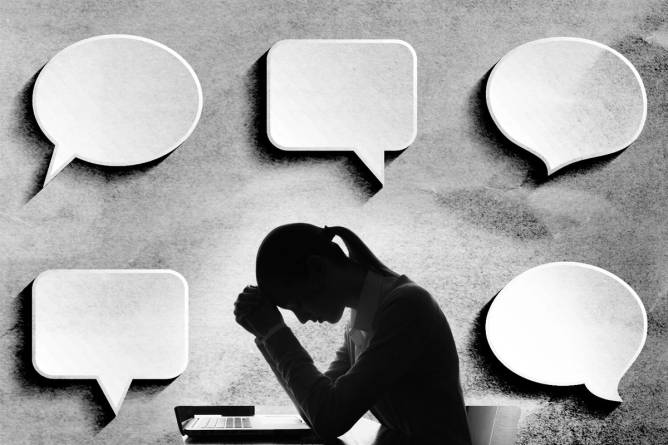 An illustration of a woman grieving at her desk. 