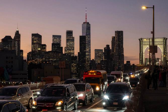 Traffic seen on the Brooklyn Bridge in New York at dusk.