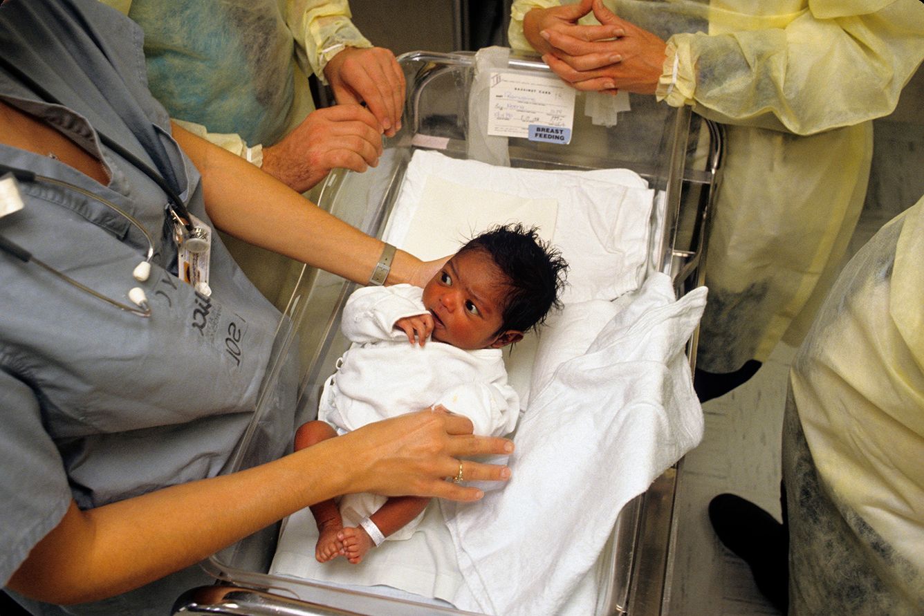 A newborn baby is presented while still in the intensive care unit.