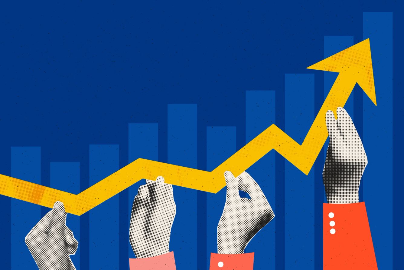 Hands holding up a yellow arrow going upward