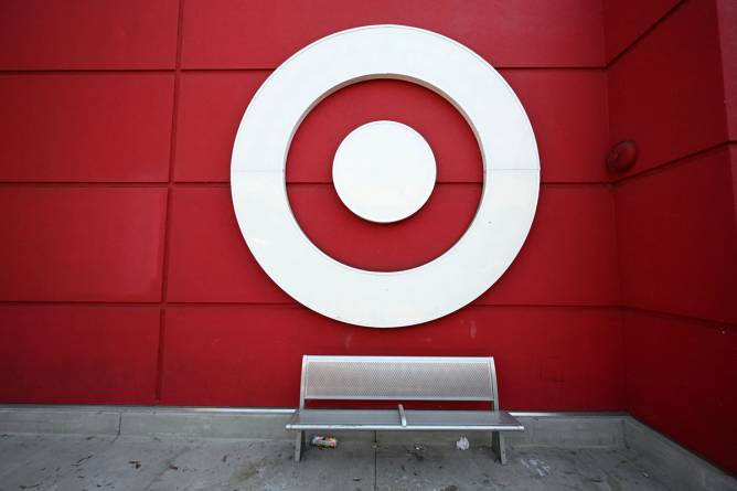 A bench in front of a red wall with the Target logo