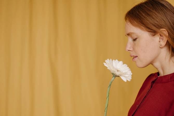 Woman smelling flower