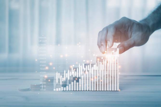 A hand reaches for the highest bar of a bar chart.