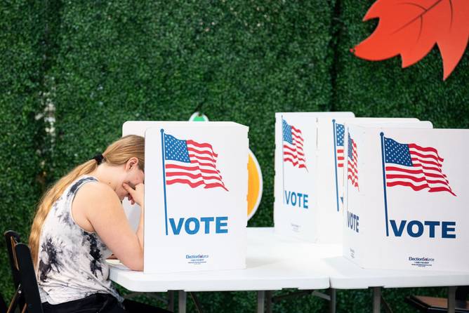 Voters fill out their ballots at The PARC At Tysons community center