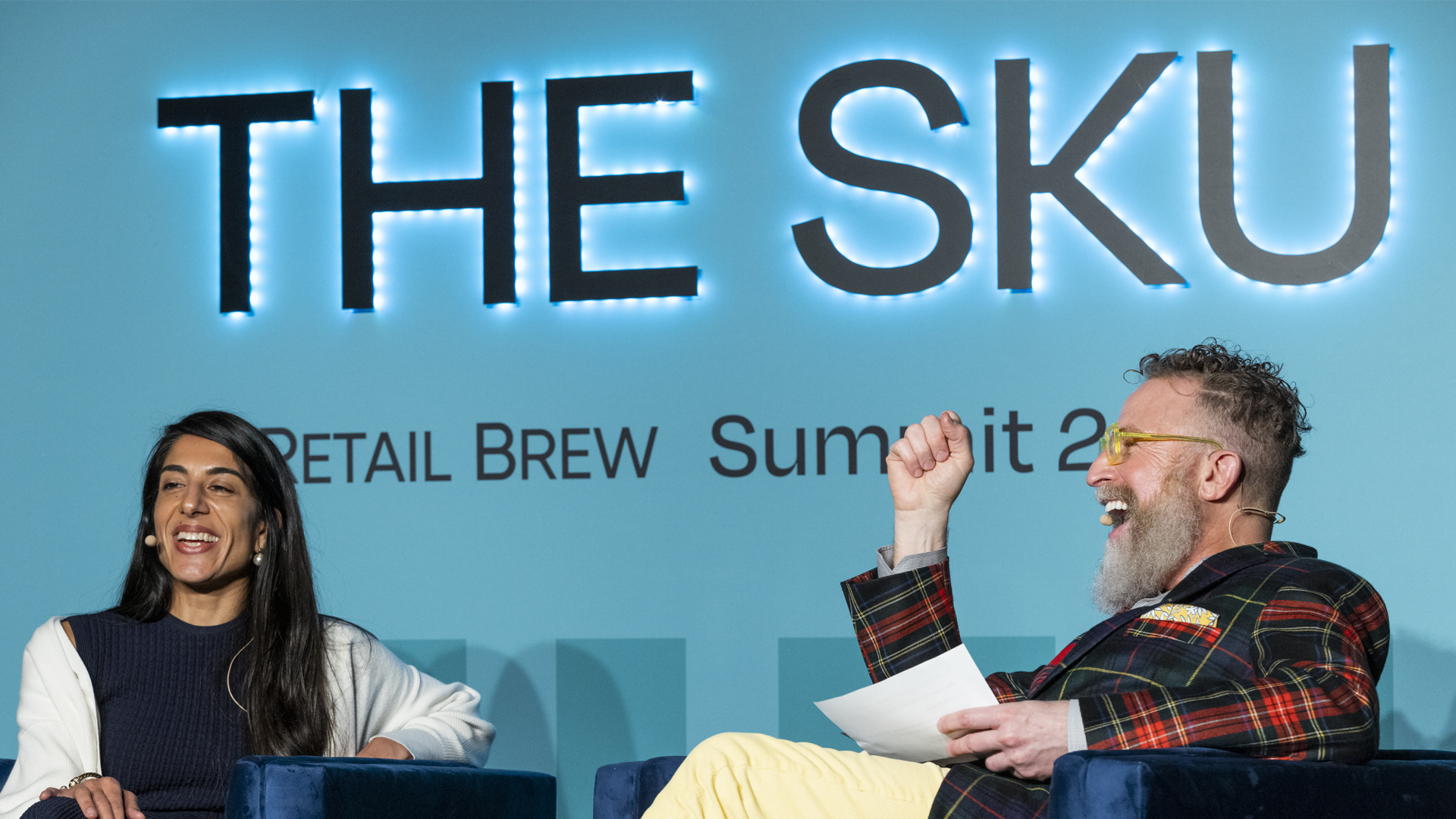 Two people on stage speaking The SKU Retail Brew Summit 2022