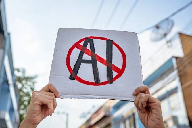 A handmade protest sign that shows AI with a strike through it.