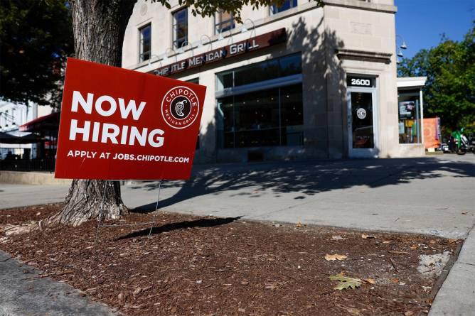 Chipotle sign that says “Now Hiring”