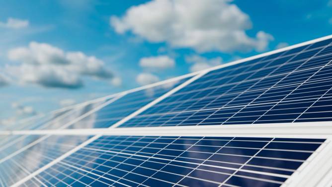 Solar panels charging under a blue sky.