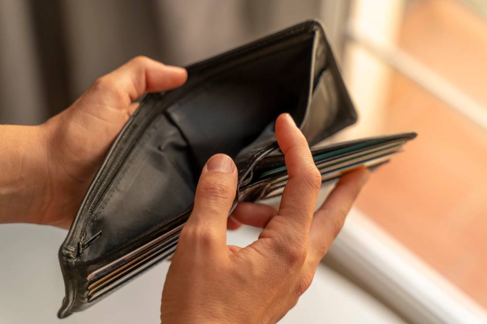 A person holding an empty wallet