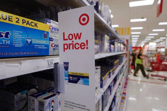 A Target store shelf with a tag advertising lower prices 