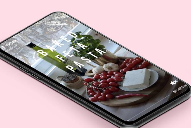 a picture of a phone with the TikTok app open; on it are the ingredients for baked feta pasta