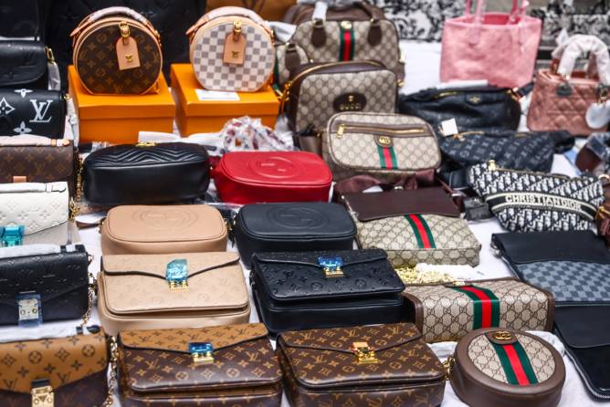 Counterfeit bags arranged on a table. 