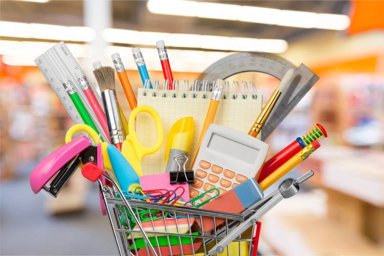 Tiny shopping cart filled with school supplies