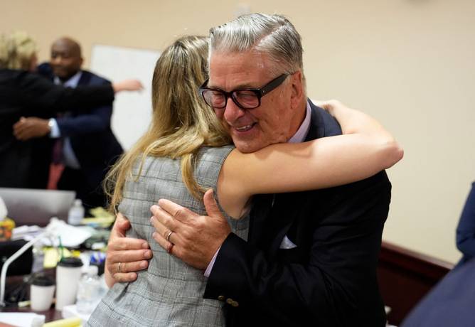 Alec Baldwin hugs a member of his legal team after involuntary manslaughter charges against him were dismissed by a judge.