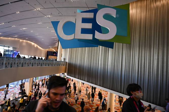 A sign reads CES Unveiled above a group of attendees at the conference in Las Vegas in January 2024.