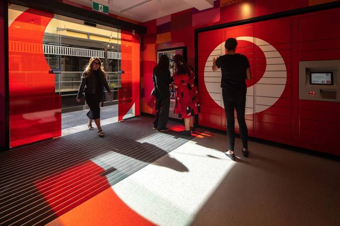 A customer enters Australia Post's newly designed post office in Orange, New South Wales.