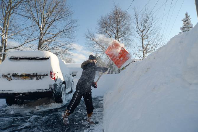 A woman digs out after 6 feet of snow fell in Buffalo