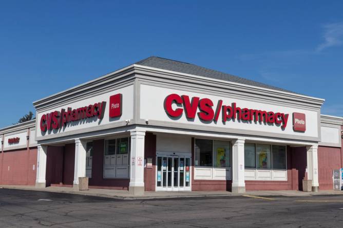 A CVS building is pictured with a parking lot outside.