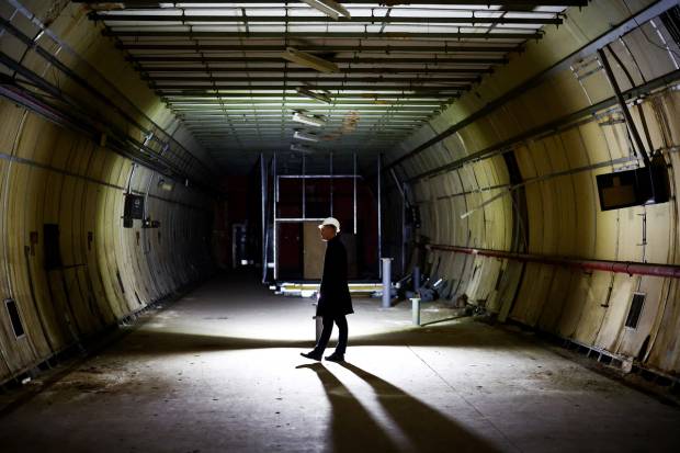 A member of the media takes part in a press tour of the underground tunnels used as a shelter during the Blitz of World War II