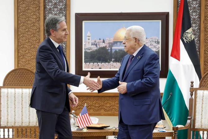 US Secretary of State Antony Blinken (L) shakeshands with Palestinian president Mahmud Abbas at the Palestinian Muqataa Presidential Compound in the West Bank city of Ramallah