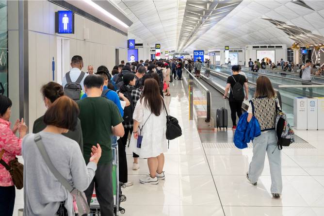 Passengers in line at airport.