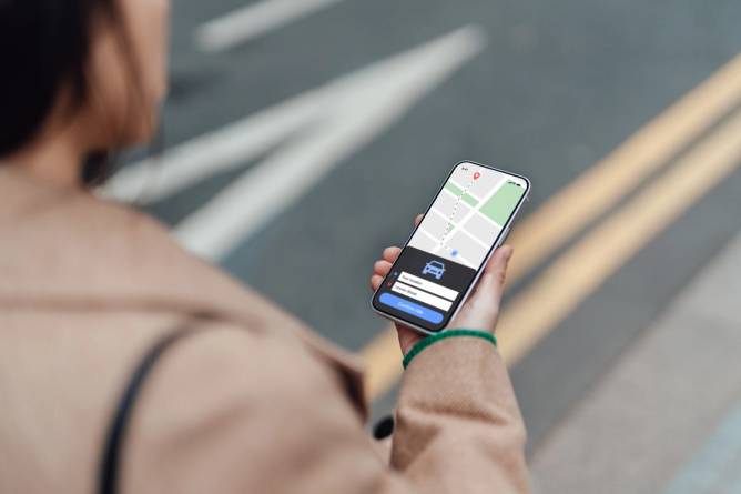 Woman ordering a ride via smartphone app.