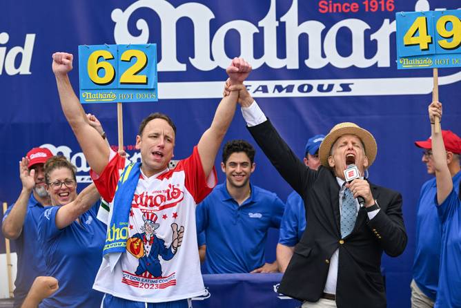 Defending champion Joey Chestnut cheers after finishing in first place in the 2023 Nathan's Famous Fourth of July International Hot Dog Eating Contest