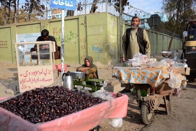 A vendor sells dates along a road in Kandahar