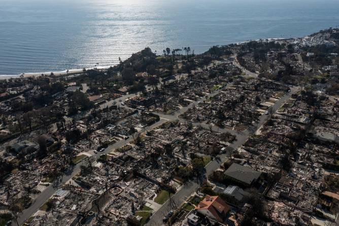 An aerial image shows homes damaged and destroyed by the Palisades Fire in the Pacific Palisades neighborhood of Los Angeles, California.