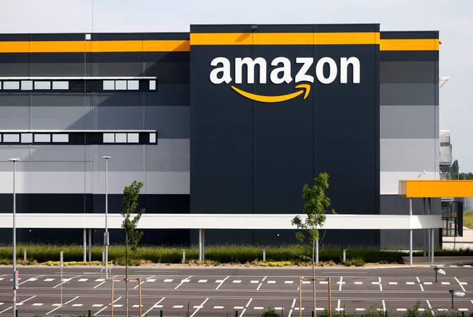 The logo of Amazon is seen on the facade of the company logistics center on April 21, 2020 in Bretigny-sur-Orge, France