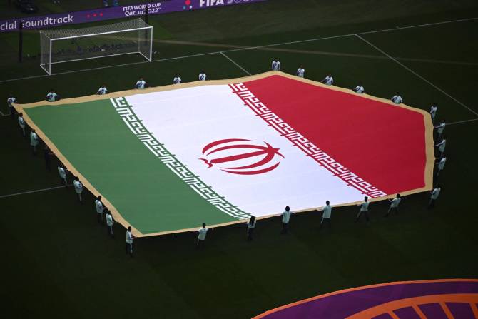 Iran's flag held out over a World Cup field