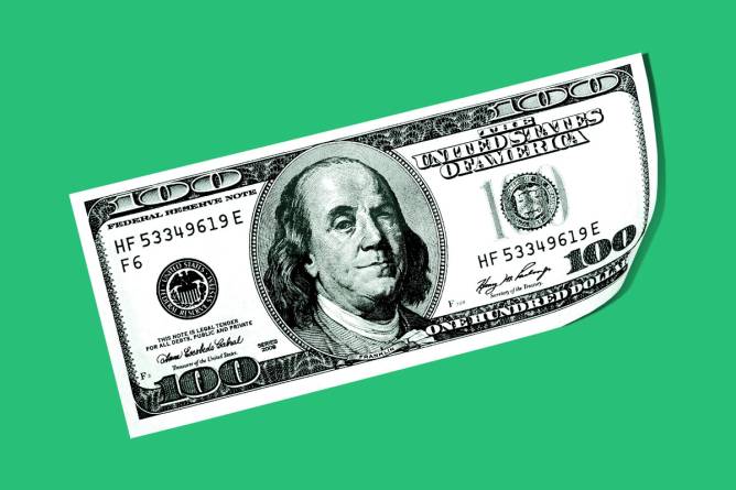 A hundred dollar bill on a green background