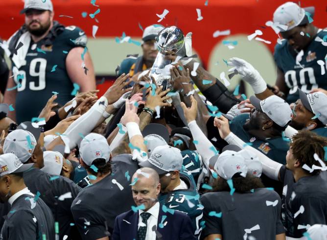 Philadelphia Eagles holding up Super Bowl LIV trophy 