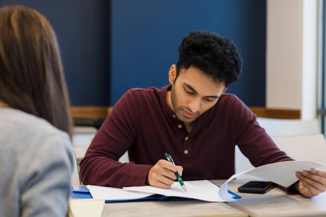 A man studying for a test. 