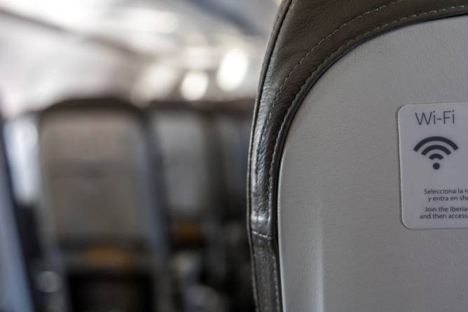 Image of a wifi symbol on the back of an airplane seat.