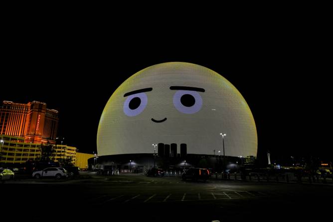 an image of an emoji face appearing on the Las Vegas Sphere at night