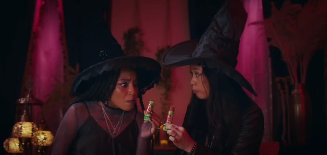 screenshot from Twix's 2023 Halloween commercial featuring two women dressed as witches