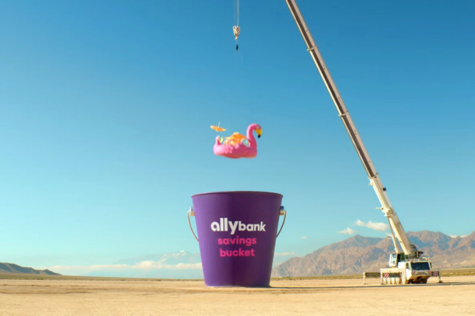 Screenshot of flamingo floaty falling into bucket from Ally 2024 ad