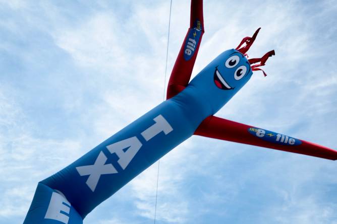 a dancing inflatable that says taxes