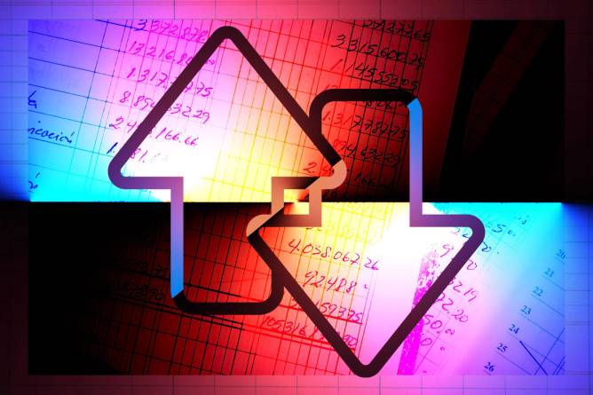 Arrows going up and down in front of accounting spreadsheets.