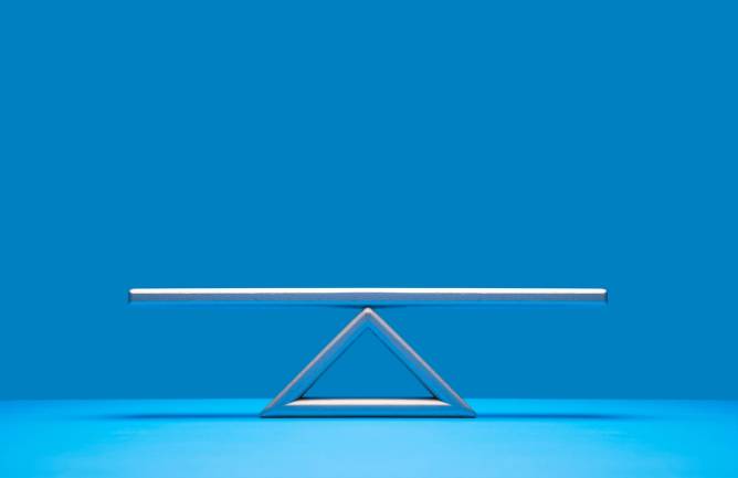 seesaw weight scale on blue background