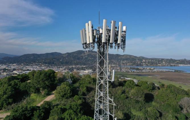 Image of a 5G tower outside of a city