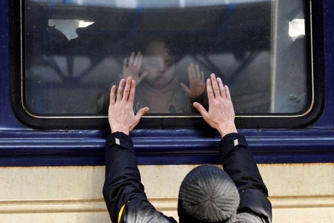 A man gestures in front of an evacuation train at Kyiv central train station on March 4