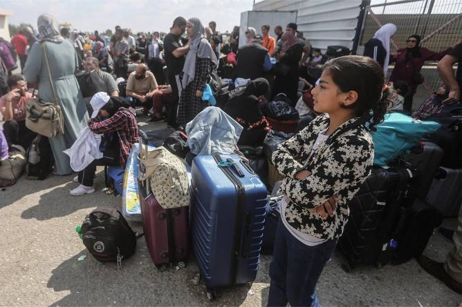 Palestinians, some with foreign passports, wait for aid and potential crossing into Egypt.