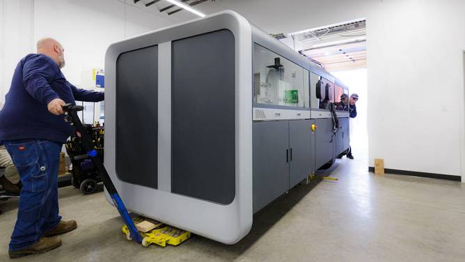 Image of a Desktop Metal 3D printer getting delivered to a customer