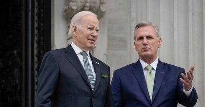 President Joe Biden standing next to Representative Kevin McCarthy