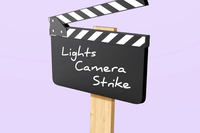 A sign says "lights camera strike"